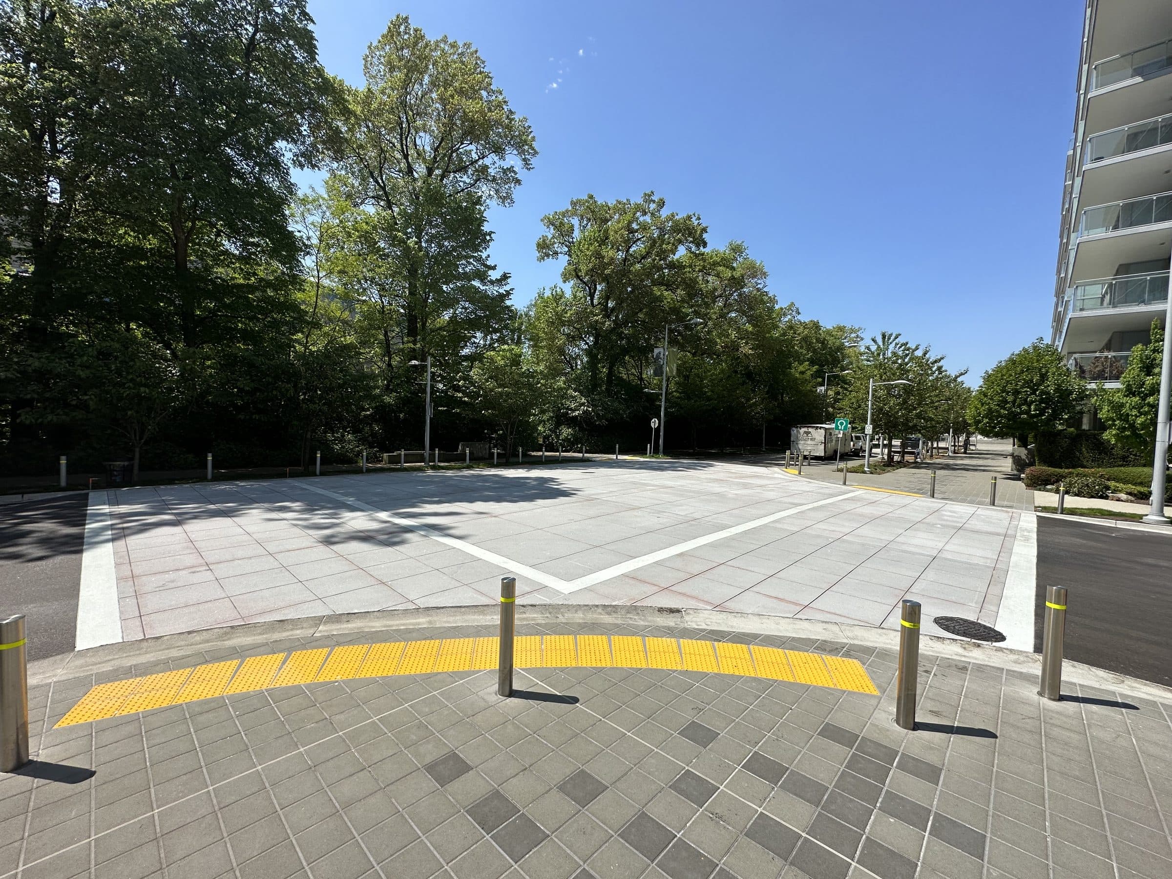 A TrafficPatternsXD crossing with a yellow tactile edge between towers in Richmond, installed by Square One