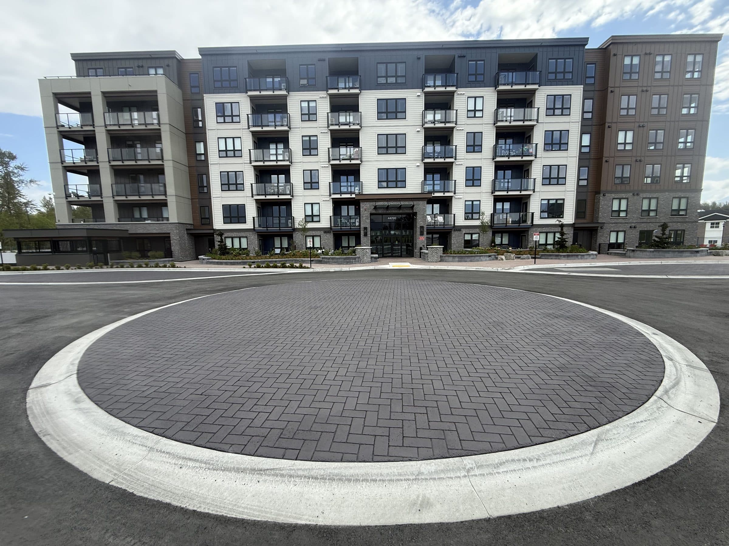 A circular turnaround in charcoal herringbone StreetPrint in front of a new apartment building in Chilliwack
