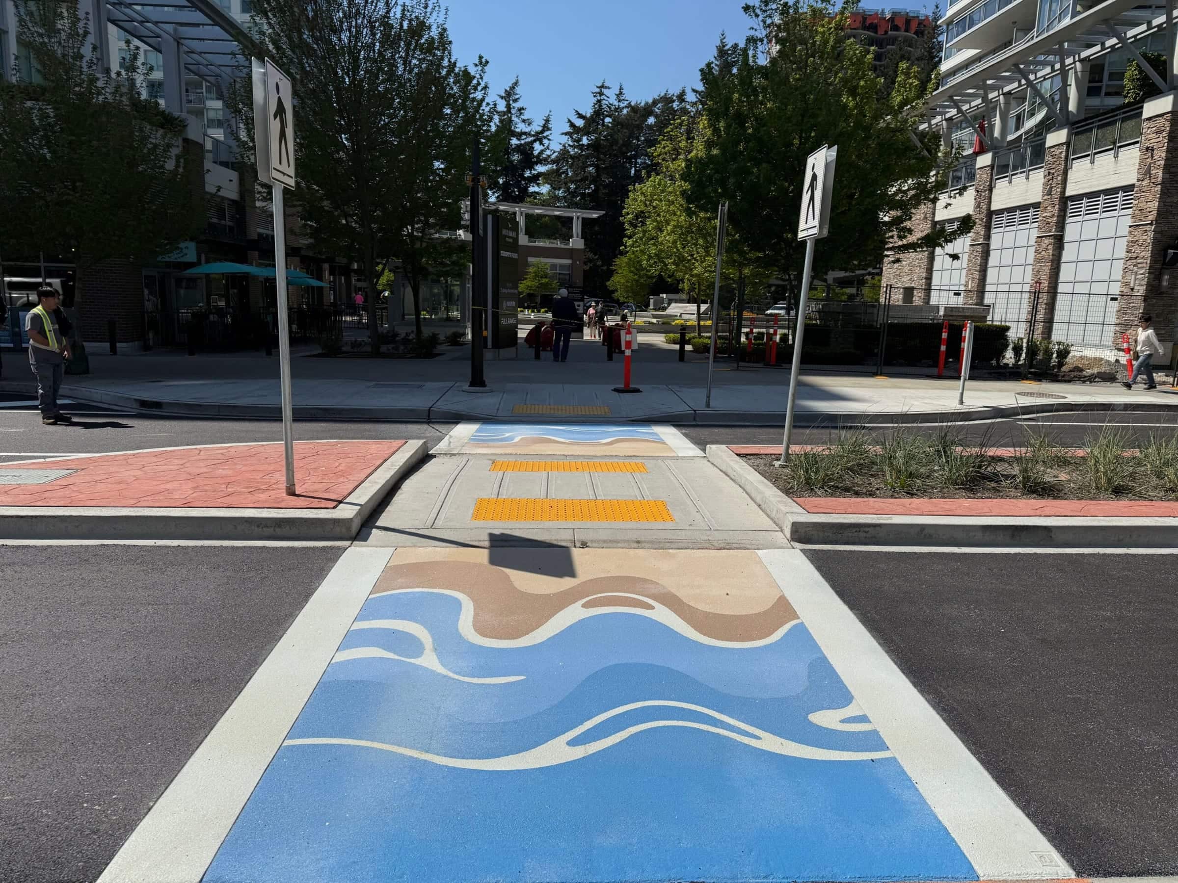 Artist-designed crosswalk of waves, sand and sky in TrafficPatterns on Marine Drive, White Rock, installed by Square One Paving